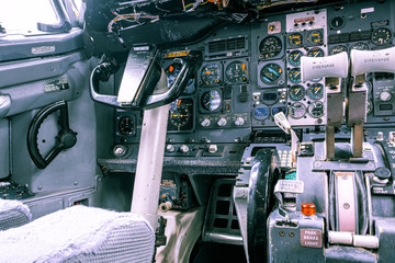 Closeup view of old aircraft cockpit with yoke and knobs
