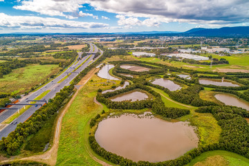 Eastlink tollway and Tirhatuan wetlands in Rowville, Victoria, Australia - aerial landscape - 345084272