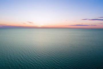 Minimalist dusk aerial seascape with copy space in water and sky
