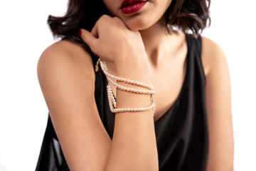 woman wearing pearl diamond wristband on white background