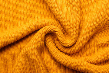 Yellow texture knitted wool scarf. Yellow textile background knitwear.
