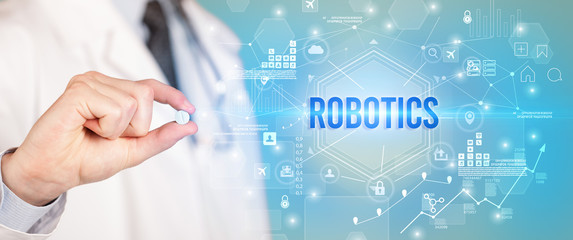 Doctor giving a pill with ROBOTICS inscription, new technology solution concept