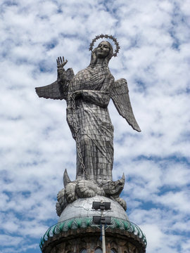 The statue Virgin of Quito with some clouds