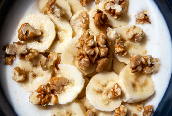 Yogurt with bananas and walnuts. Texture.