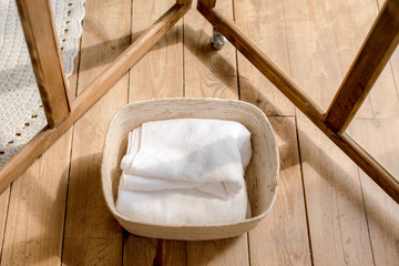 Fototapeta na wymiar basket with towels on wooden background