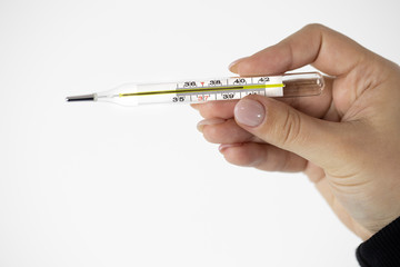 Mercury glass thermometer in female hand which shows extremely high temperature above 40 degrees isolated on white black background. Temperature check during covid-19 coronavirus outbreak, high fever