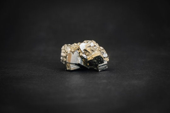 Pyrite crystal on black background. Copy, empty space for text