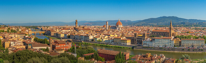 Fototapeta na wymiar Fascinating panoramic view of the city of Florence at summer's noon. Travel destination Tuscany, Italy