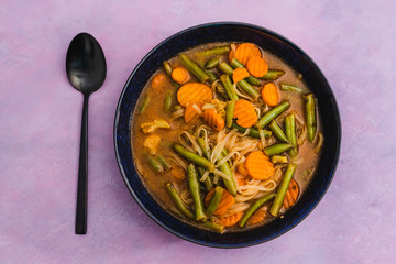plant-based food, vegan carrot and green beans soup with vegetable broth