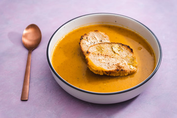 plant-based food, vegan carrot onion and celeri soup with homemade bread
