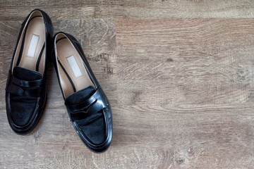 Loafers and other shoes retro style stand on the wooden floor.