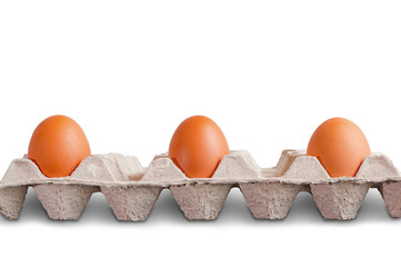 Three eggs in egg carton with distance , no social distancing ,  on white background with clipping path