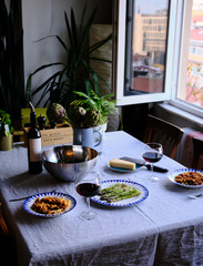 Lunch table with Tagliatelle Pasta with Bolognese Sauce, Baked Asparagus, parmesan cheese, salad and red wine