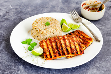 Grilled Paneer Steaks with Herbed Rice and Piri Piri Sauce, Garnished with Lemon, Cilantro and Mint Leaves, Indian Food Photo graphy