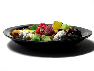 Plate with fruit and nut mixture on white background