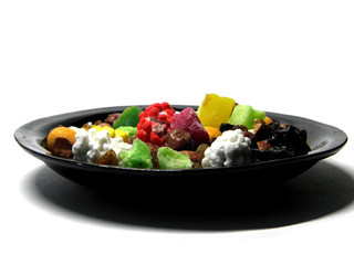 Plate with fruit and nut mixture on white background