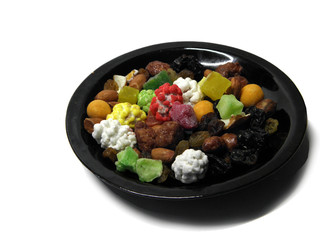 Plate with fruit and nut mixture on white background