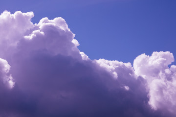 Fototapeta na wymiar Fluffy pink clouds in the sunlight, background