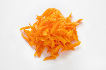 orange, fresh, grated carrots on a white background isolate
