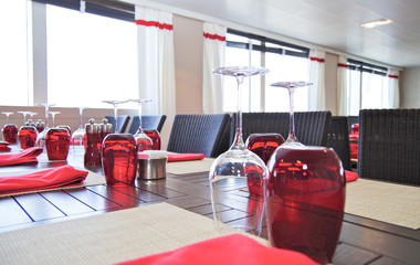 View into modern restaurant with set tables on luxury cruiseship or cruise ship liner with red...