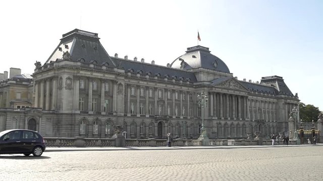 A smooth travelling wide shot of the Royal Palace in Brussels, Belgium with traffic in front of it.Video shot on a gimbal on a sunny summer day.