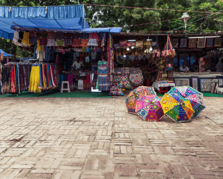 New Delhi, India - August 5, 2018: Shops and umbrellas at Dilli Haat food and handicraft bazar in New Delhi