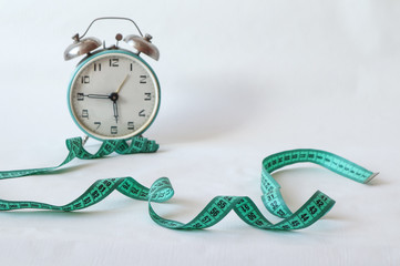 Watch with a centimeter on a white background, place for the inscription