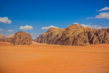 Fototapeta na wymiar gorgeous Wadi Rum panoramic landscape beautiful famous travel destination site of Jordan desert aerial photography with sand valley foreground and rocky mountains horizon background in summer day