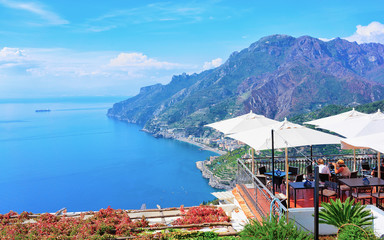 Open air street restaurant with umbrellas in Ravello village reflex