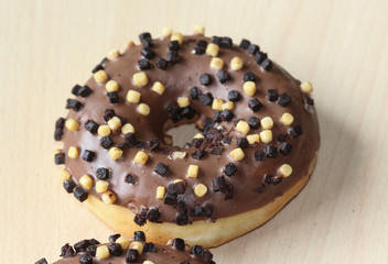 chocolate brownie donuts on table. The donuts is brown glazed with brownie parts