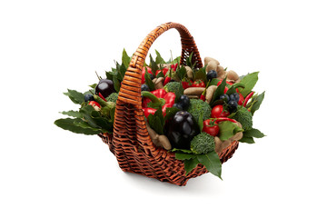 Wicker basket filled with various fresh ripe vegetables on a white background