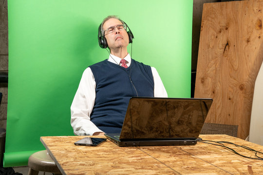 Man Working From Home In His Basement On A Virutal Meeting.