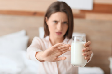 Young woman with milk allergy in bedroom