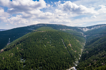 beautiful view of the mountains covered with spruce trees with a beautiful sky in Jeseniky mountains, czech Dlouhe Strane 18.4.2020