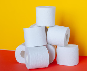 Rolls of toilet paper on color background