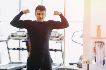 Fototapeta na wymiar stylish guy in the gym posing for a photo. Healthy Lifestyle.