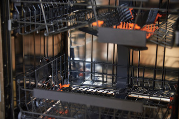 Open an empty dishwasher. Appliances in the kitchen