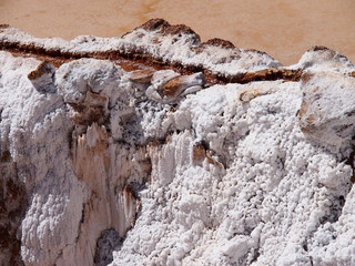 Sunny and brown Salt Mines in Maras, Peru 