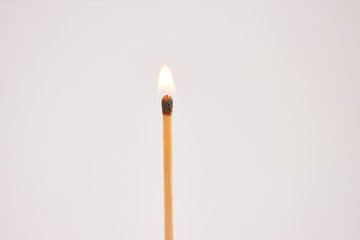 Burning match on white background