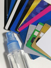 Bank plastic cards and a bottle of disinfectant solution.