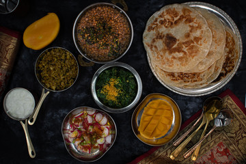Noth Indian vegetarian dishes on dark table