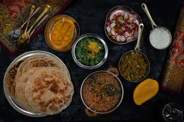 Noth Indian vegetarian dishes on dark table