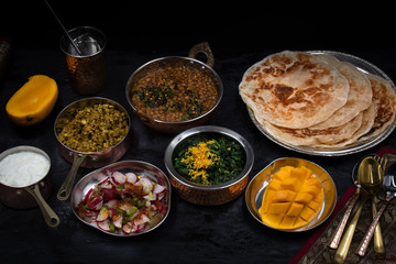 Noth Indian vegetarian dishes on dark table
