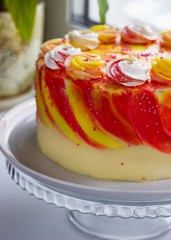 Bright festive cake with roses on the windowsill