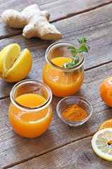 Ginger shot with citrus fruits juice, turmeric and honey. Pure vegan Immunity system booster. Copy space