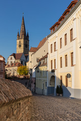 Lutheran Church with iconic bell tower in Sibiu on a beautiful sunny afternoon - 345103655