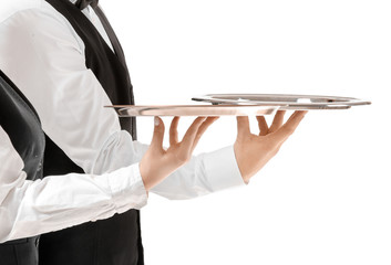 Male and female waiters with empty trays on white background