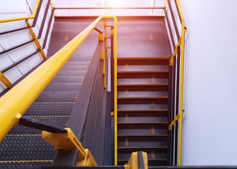 Fire escape staircase or emergency staircase with clearly marked walkway with yellow arrows.