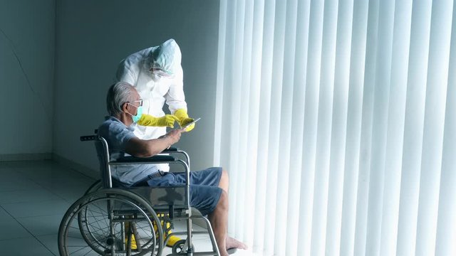 Elderly man describing his symptoms to a doctor