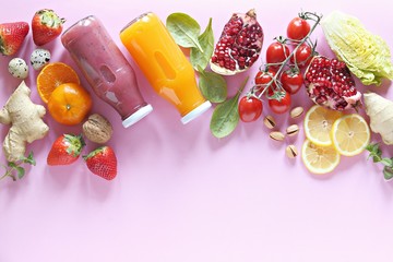 Flat-lay of fruits, berries, vegetables, ginger shot and fruit smoothie on pink background. Copy...
